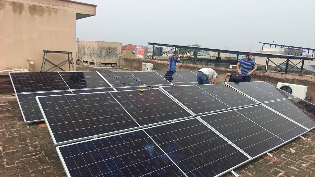 SunMax Energy Solutions technicians installing solar panels on a rooftop